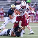 Cascades Max Nelson (right) attempts to break a tackle by Everetts Christian Balmer Friday night at Everett Memorial Stadium in Everett on August 31, 2018. Cascade won 32-22. (Kevin Clark / The Herald)