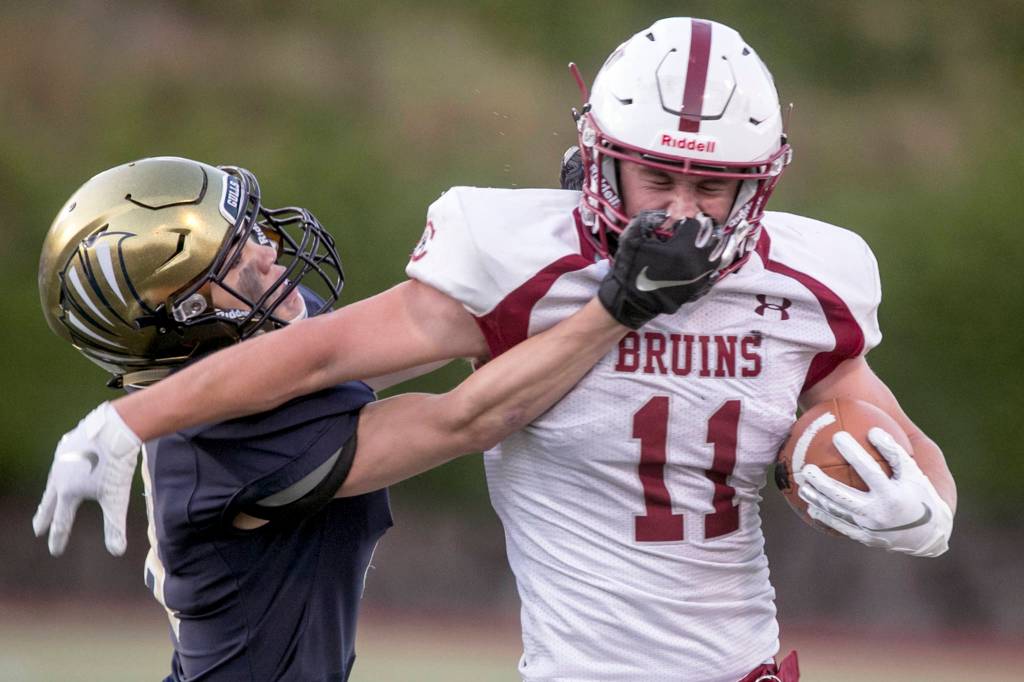 Everetts Ryan Sphung tackles and is penalized for a face mask on Cascades Max Nelson Friday night at Everett Memorial Stadium in Everett on August 31, 2018. Cascade won 32-22. (Kevin Clark / The Herald)
