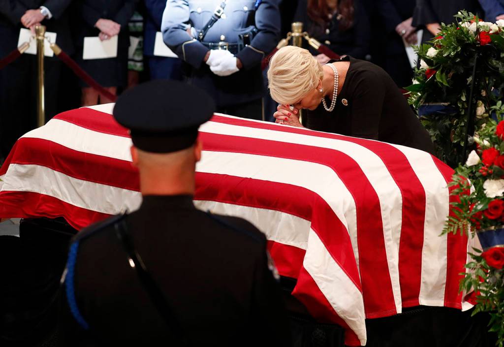Cindy McCain, wife of Sen. John McCain, pauses at her husbands casket during ceremonies honoring McCain at the U.S. Capitol Rotunda in Washington on Friday. (Kevin Lamarque/Pool Photo via AP)