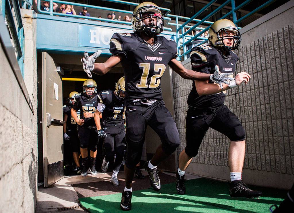 Lynnwoods Zaki Emam runs out of the locker room cheering before Fridays game against Nathan Hale on Aug. 31, 2018 in Edmonds, Wa. (Olivia Vanni / The Herald)