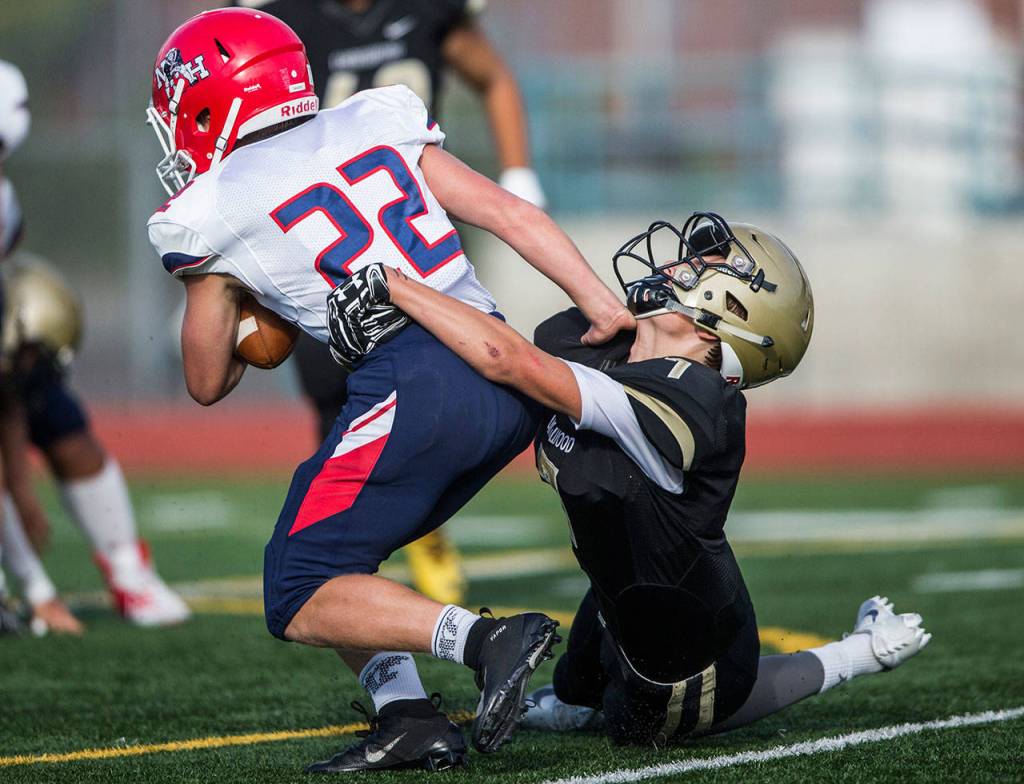 Lynnwoods Shawn Monan tackles Nathan Hales Finn Davido during Fridays game against Nathan Hale on Aug. 31, 2018 in Edmonds, Wa. (Olivia Vanni / The Herald)