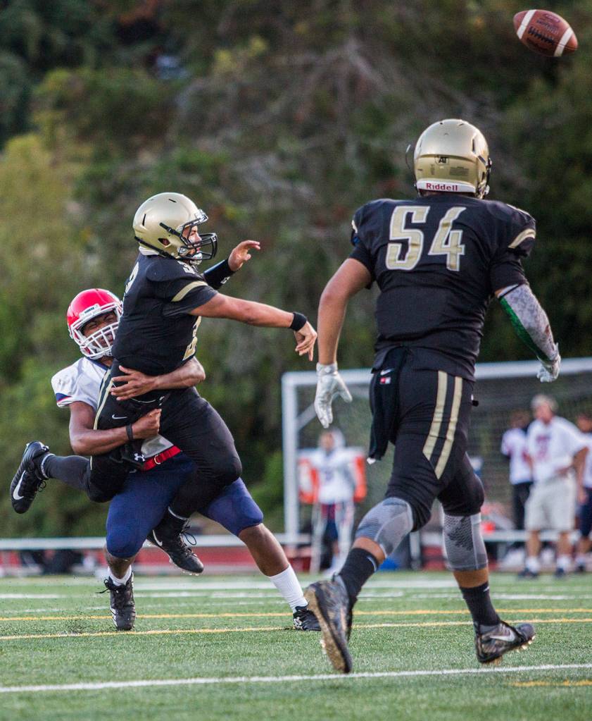 Lynnwoods Christian Kirkman makes a throw before being tackled during Fridays game against Nathan Hale on Aug. 31, 2018 in Edmonds, Wa. (Olivia Vanni / The Herald)
