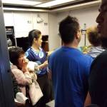 This Aug. 31 photo shows people gathered in a back galley on a Hawaiian Airlines flight from Oakland, California, to Kahului, Hawaii, after a can of pepper spray went off inside the plane. (Nicholas Andrade via AP)