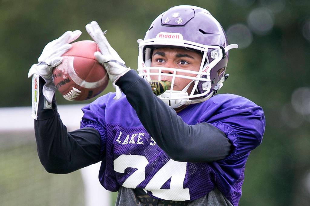 Kasen Kinchen makes a catch during practice at Lake Stevens High School on Aug. 23. (Kevin Clark / The Herald)