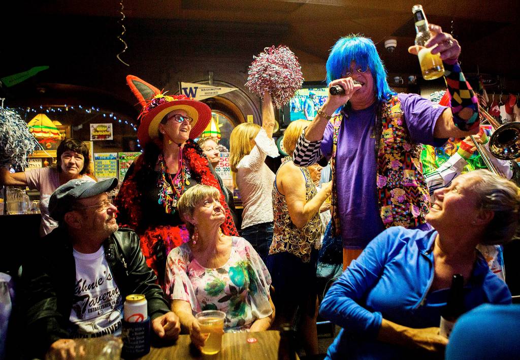 Gordon Taylor of the Sauerkraut Band tells patrons to raise their drinks during Kuhnles Taverns 100-year-old celebration on Aug. 25 in Marysville. (Olivia Vanni / The Herald)
