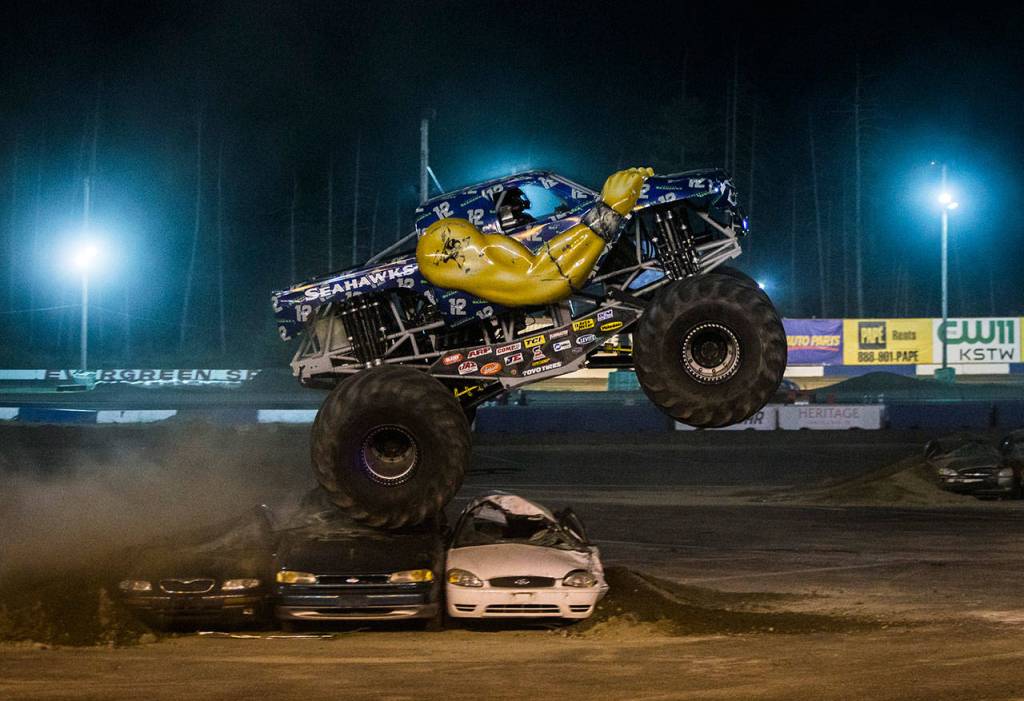 A monster truck driver is illuminated in their cab during Monster Trucks at the Evergreen State Fair on Aug. 24, 2018 in Monroe, Wa. (Olivia Vanni / The Herald)