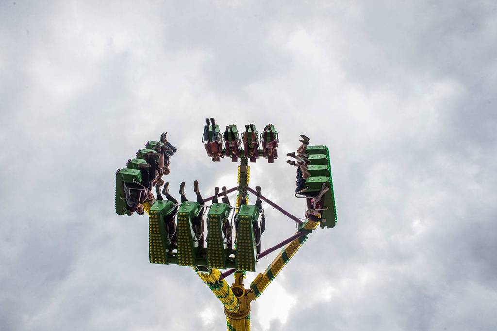 People scream on a ride at the Evergreen State Fair on Aug. 23, 2018 in Monroe, Wa. (Olivia Vanni / The Herald)