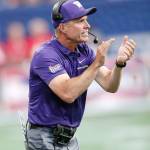 Washington coach Chris Petersen encourages his players during the first half of the Huskies 21-16 loss to Auburn on Saturday in Atlanta. (AP Photo/John Bazemore)