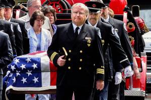 Ken Gaydos, a longtime police and fire department chaplain in south Snohomish County, leads a procession during the 2006 funeral for Charles Chuck Cain, a member of the Edmonds Fire Safety Foundation. Gaydos died Monday. He was 79. (Herald file)