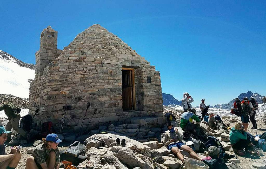 Hikers take a break outside the Muir Hut at the top of Muir Pass.