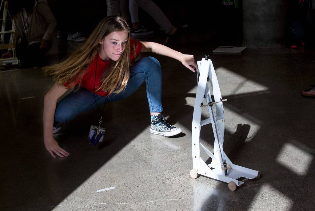 Fifth-grader Frankee Powers walks behind her teams gravity car as it moves down a hallway at the University of Washington on Wednesday, Sept. 12, 2018 in Seattle, Wa. Students from Marshall Elementary in Marysville built gravity cars as part of a one week engineering program. (Andy Bronson / The Herald)
