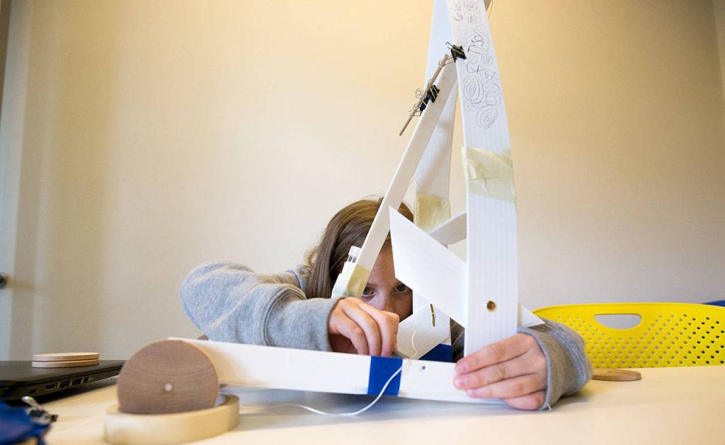 Marshall Elementary fifth-grader Lyric Kroeger works on building a gravity car, as part of a one week engineering program, at the University of Washington on Wednesday, Sept. 12, 2018 in Seattle, Wa. (Andy Bronson / The Herald)
