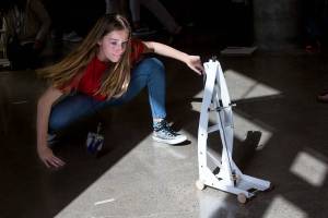 Fifth-grader Frankee Powers walks behind her teams gravity car as it moves down a hallway at the University of Washington on Wednesday, Sept. 12, 2018 in Seattle, Wa. Students from Marshall Elementary in Marysville built gravity cars as part of a one week engineering program. (Andy Bronson / The Herald)