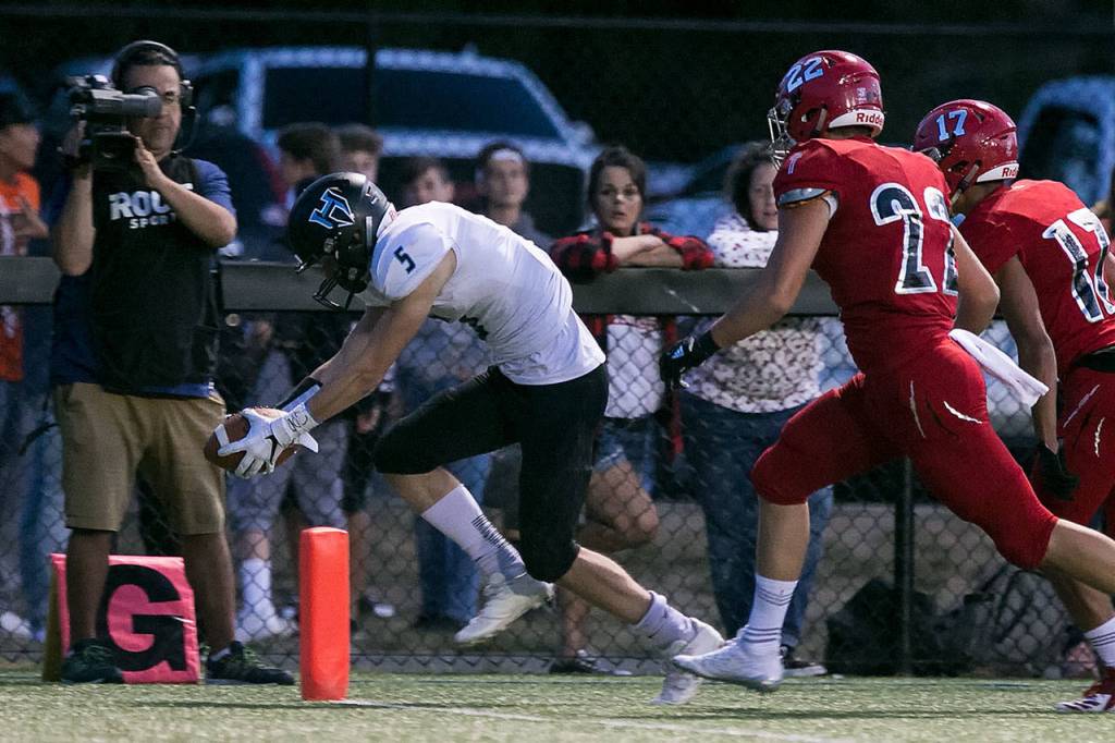 Hockinsons Wyatt Jones crosses the goal line for a touchdown with Archbishop Murphy defenders trailing during a game on Sept. 6, 2018, at Archbishop Murphy High School in Everett. (Kevin Clark / The Herald)