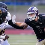 Lake Stevens Ian Hanson stiff-arms a pair of Lincoln defenders during a game on Sept. 7, 2018, at Lake Stevens High School. Lake Stevens won 38-21. (Kevin Clark / The Herald)