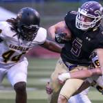 Lake Stevens Tom Lewis is tackled by Lincolns Troy Atkin with Lincolns Janoah Thomas (left) closing during a game on Sept. 7, 2018, at Lake Stevens High School. Lake Stevens won 38-21. (Kevin Clark / The Herald)
