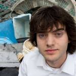 In this May 2017 photo, Dutch innovator Boyan Slat poses for a portrait next to a pile of plastic garbage prior to a press conference in Utrecht, Netherlands. (AP Photo/Peter Dejong, File)