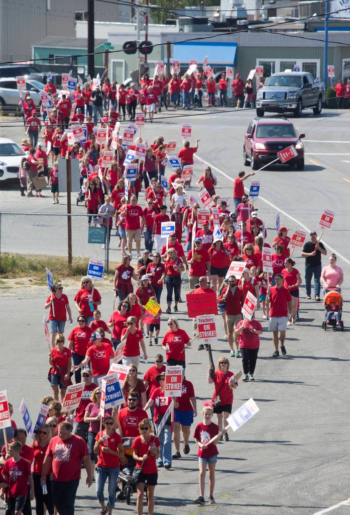 Stanwood teachers march through downtown and to the district office as they strike on Sept. 4, 2018, in Stanwood. (Andy Bronson / The Herald)