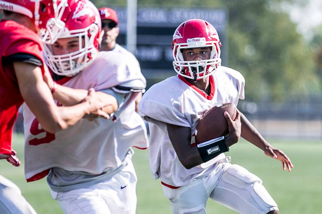 Bryan Sanders (right) rushes for yardage during practice at Quil Ceda Stadium in Marysville on Sept. 6, 2018. (Kevin Clark / The Herald)