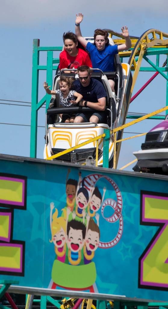 Riders seem to mimic the sign on The Zillarator as they ride atthe Evergreen State Fair on Sept. 3, 2018, in Monroe. (Andy Bronson / The Herald)