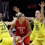 Washingtons Elena Delle Donne (11) looks for room to pass as Seattles Sami Whitcomb (33) and Breanna Stewart defend in the first half of Game 2 of the WNBA finals Sunday in Seattle. (AP Photo/Elaine Thompson)