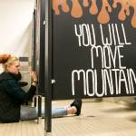 Madison Smith paints a stall in the girls room at Crossroads High School in Granite Falls on Sept. 11. (Kevin Clark / The Herald)
