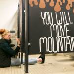 Madison Smith paints a stall in the girls room Tuesday afternoon at Crossroads High School in Granite Falls on September 11, 2018. (Kevin Clark / The Herald)