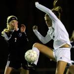 Jacksons Keile Hansen jumps for a loose ball with Lake Stevens Callaway Knutson defending Nov. 2, 2017, night at Goodard Stadium in Everett. (Kevin Clark / Herald file)