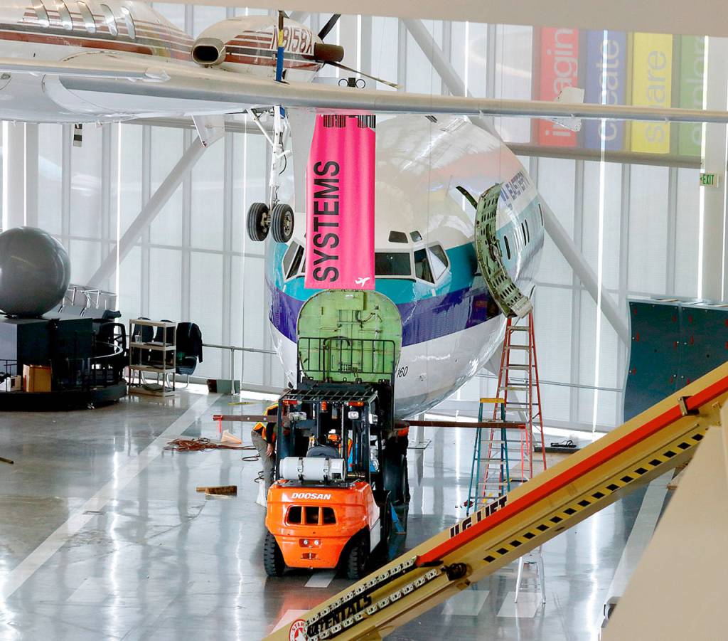 Workers this week prepare to move the nose section of a Boeing 727 with a forklift at the Future of Flight Aviation Center in Mukilteo. (Contributed photo)