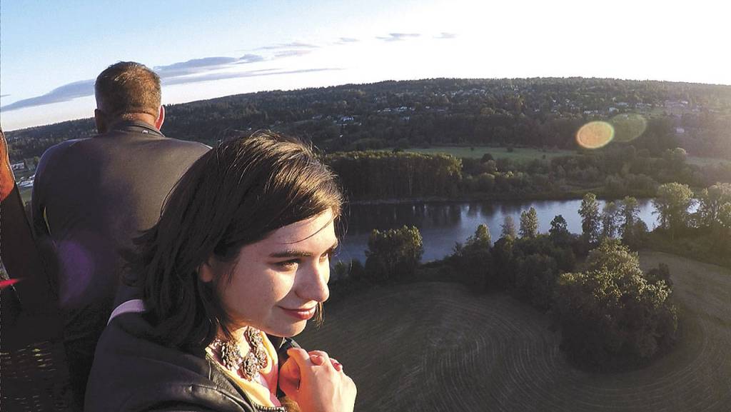 Emily Kennedy watches the scenery around her during a hot air balloon trip. (Andy Bronson / The Herald)