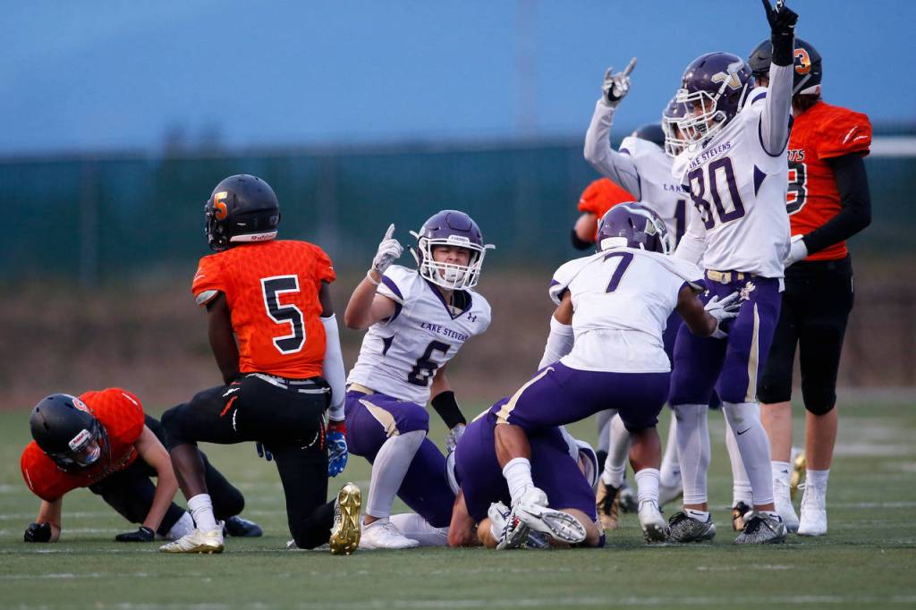 Lake Stevens players celebrate after recovering a pooch kick in the second quarter of Friday nights game in Monroe. (Andy Bronson / The Herald)