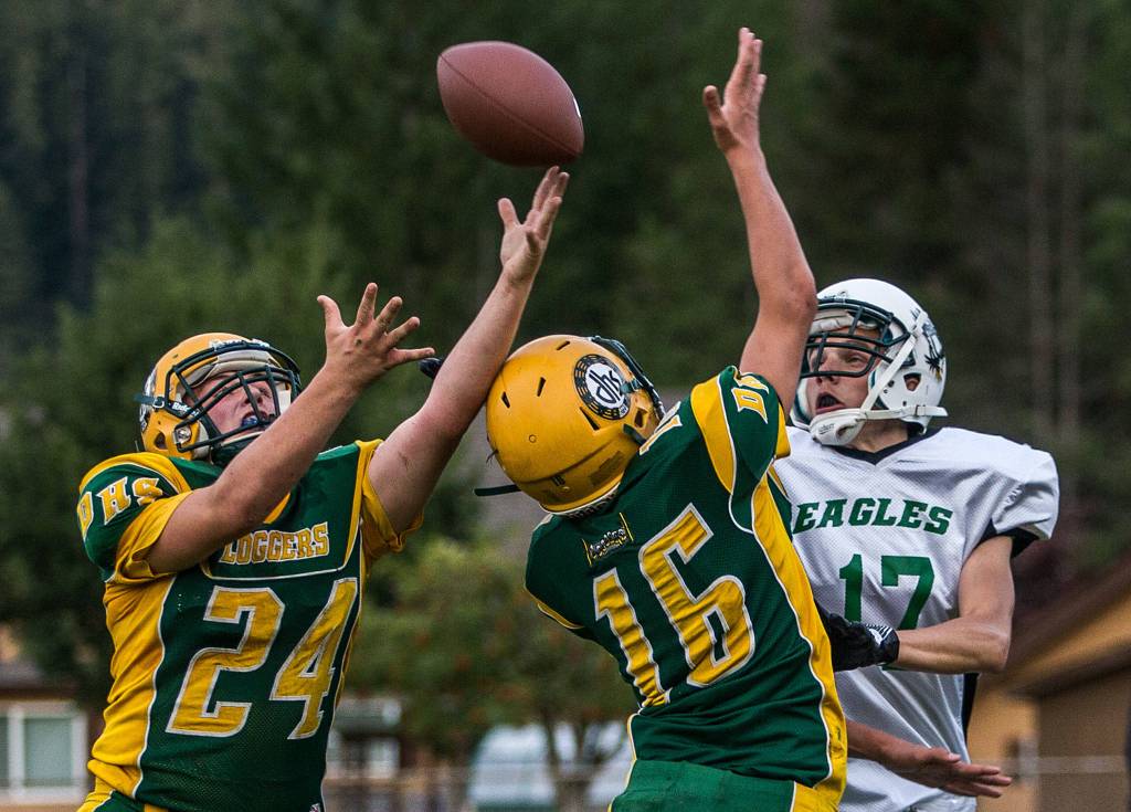 Darrington’s Leevi Whittaker and Ashton Weidman defend a pass in the Loggers’ 44-0 rout of Evergreen Lutheran on Friday night. Darrington has posted back-to-back shutouts. (Olivia Vanni / The Herald)
