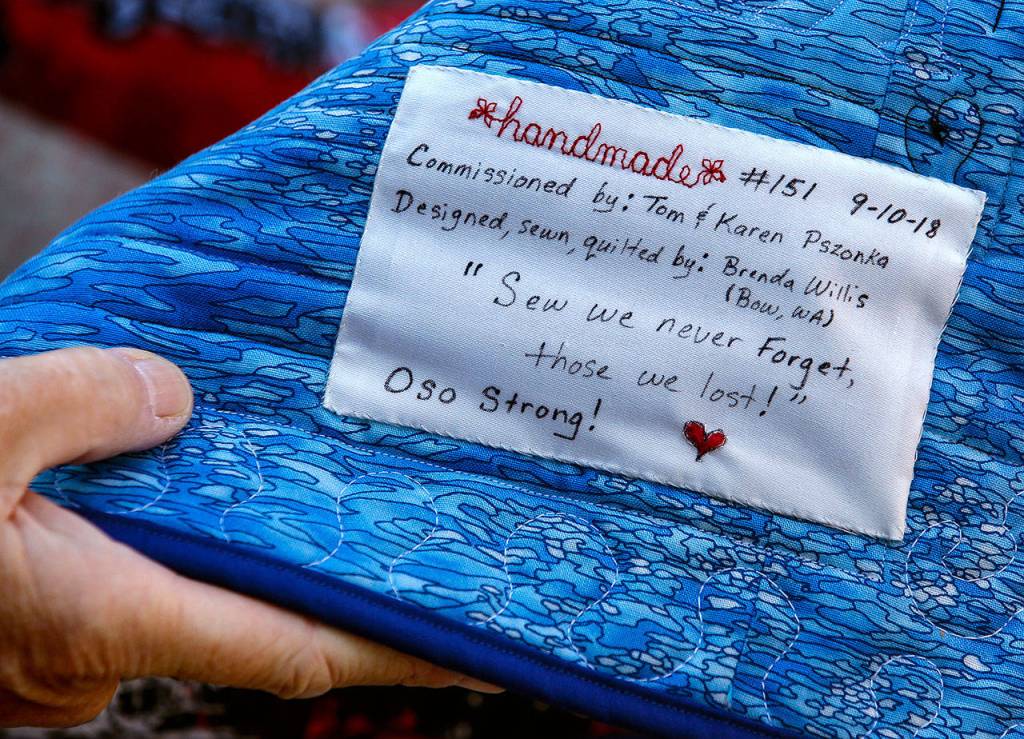 A tag on the back of the special quilt helps explain the unexplainable. (Dan Bates / The Herald)