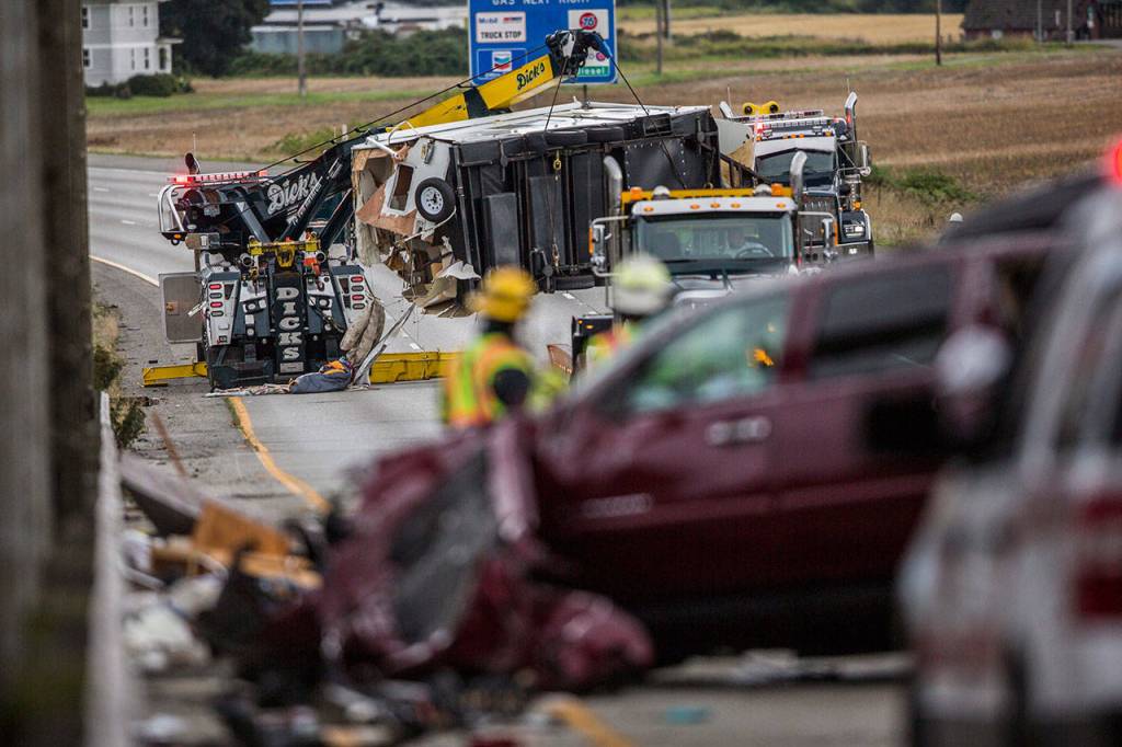 A trailer on I-5 southbound north of the Highway 530 interchange is lifted onto a tow truck Sunday afternoon in Arlington. (Olivia Vanni / The Herald)