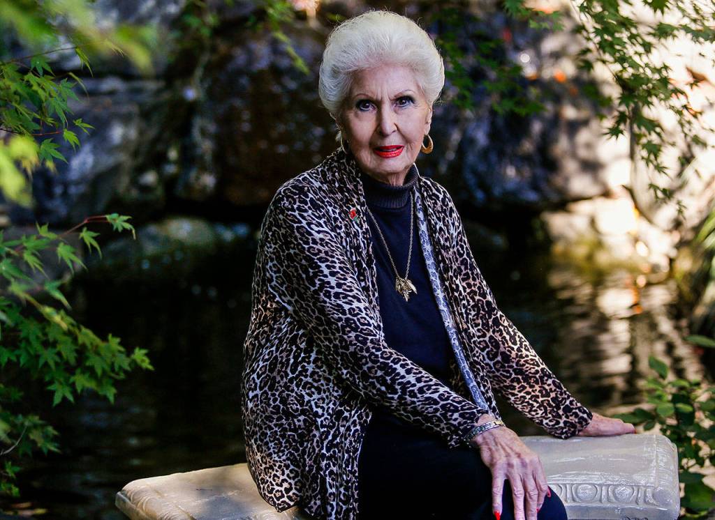 Donna Leifer, 88, sits near a waterfall where many a bride has posed for photos on her wedding day. Her own back yard became the Leifer Manor wedding venue 27 years ago. (Dan Bates / The Herald)