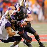 Utah wide receiver Samson Nacua (45) is tackled by Washingtons Taylor Rapp (7) and Ben Burr-Kirven (25) in the first half of the No. 10 Huskies 21-7 win over the Utes on Saturday in Salt Lake City. (AP Photo/Rick Bowmer)