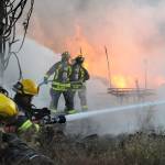 Firefighters from Snohomish, Lake Stevens and Everett assist at a fire that destroyed a large out building on Fobes Road west of Snohomish on Monday night. (Doug Ramsay for The Herald)