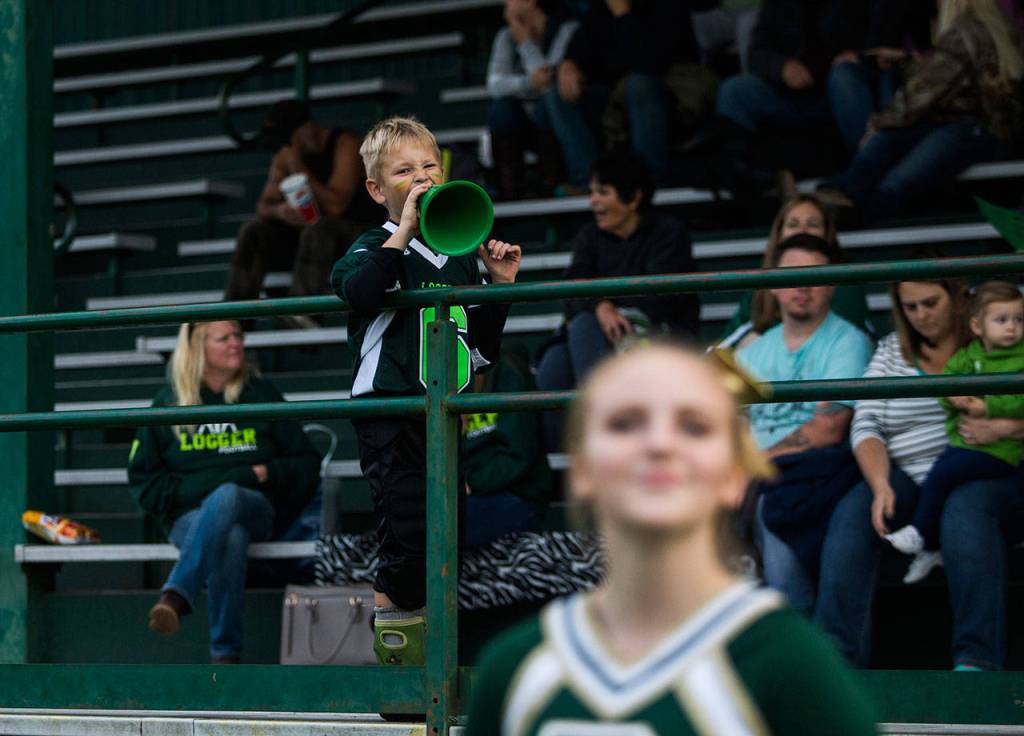Darrington fan Preston Spelman cheers on the Loggers during their 44-o win over Evergreen Lutheran on Sept. 14 in Darrington. (Olivia Vanni / The Herald)