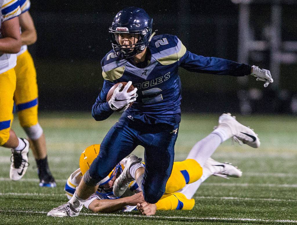 Arlingtons Bryce Petersen escapes a tackle during a game against Ferndale on Sept. 21, 2018, in Arlington. (Olivia Vanni / The Herald)