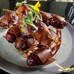 The cashew blue cheese stuffed dates wrapped with vegan prosciutto is part of menu aimed at being approachable to non-vegans. (Sharon Salyer / The Herald)