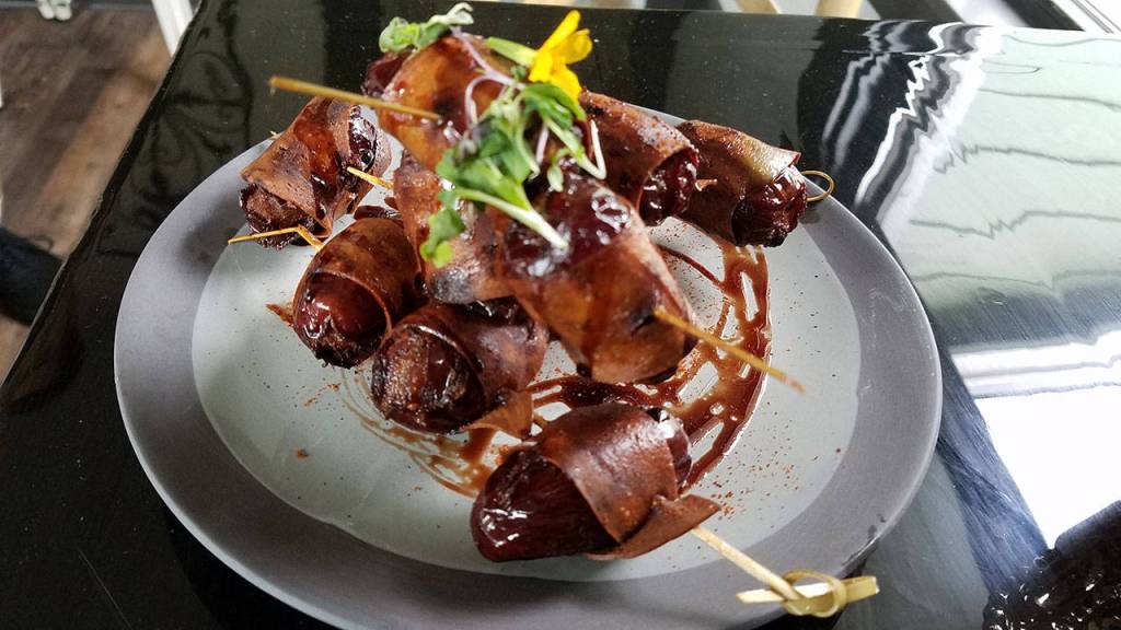 The cashew blue cheese stuffed dates wrapped with vegan prosciutto is part of menu aimed at being approachable to non-vegans. (Sharon Salyer / The Herald)