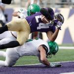 Washingtons Kamari Pleasant (24) dives into the end zone for a touchdown against North Dakota on Sept. 8, 2018, in Seattle. (AP Photo/Elaine Thompson)