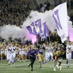 Dubs II, the Washington Huskies mascot, leads the team out of the tunnel for its game against Arizona State last Saturday night in Seattle. (AP Photo/Ted S. Warren)