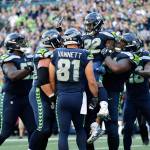 Seahawks running back Chris Carson (32) is lifted by offensive guard D.J. Fluker after Carson scored a touchdown against the Cowboys during the second half of a game on Sept. 23, 2018, in Seattle. (AP Photo/John Froschauer)