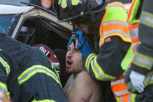 First responders work to free a driver of a two-car accident on the 7100 block of Evergreen Way Wednesday afternoon in Everett on September 26, 2018 (Kevin Clark / The Herald)