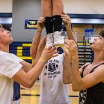 Cody Bennett (left) and Judah Nanto (right) help pop off during rehearsal in the Everett High School gym on Sept. 26. (Olivia Vanni / The Herald)