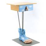 A blue boot covers the large resin foot that is the base of a 25-inch-high table, which sold for only $175. Its a conversation piece for a quirky home. (Cowles Syndicate Inc.)