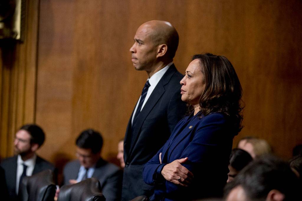 Sen. Cory Booker, D-N.J., and Sen. Kamala Harris, D-Calif., listen as Sen. Jeff Flake, R-Ariz., speaks during a Senate Judiciary Committee hearing on Supreme Court nominee Judge Brett Kavanaugh on Friday on Capitol Hill in Washington. (AP Photo/Andrew Harnik)