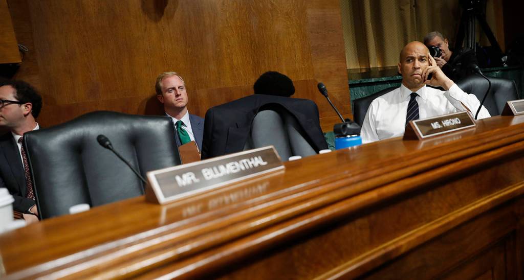 Sen. Cory Booker, D-N.J., looks past empty seats after Democratic members of the Senate Judiciary Committee walked out of the meeting, Friday on Capitol Hill in Washington. (AP Photo/Pablo Martinez Monsivais)