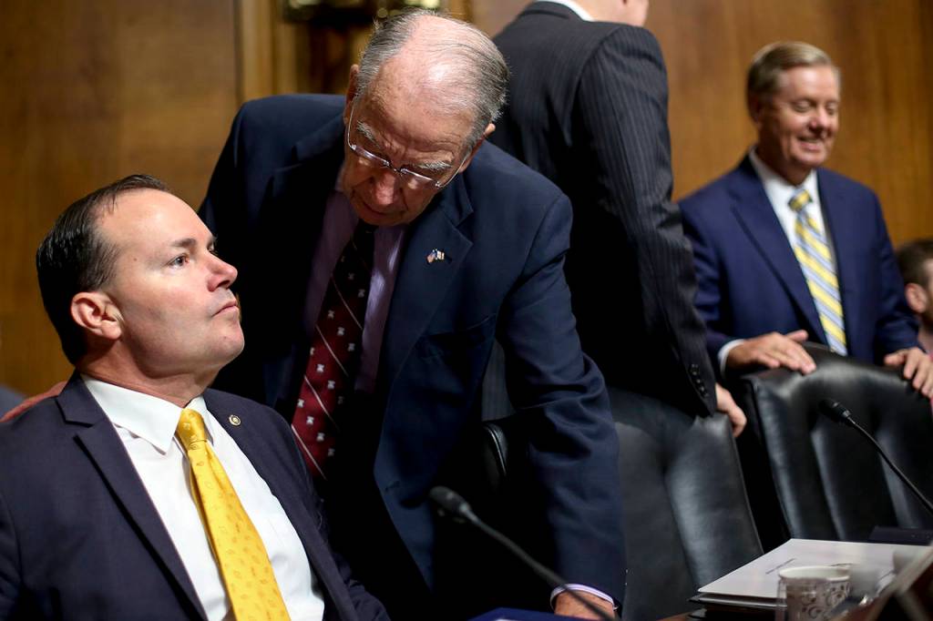 Senate Judiciary Committee Chairman Chuck Grassley of Iowa (second from left) speaks with Sen. Mike Lee, R-Utah (left), before a meeting of the committee Friday on Capitol Hill in Washington. (AP Photo/Pablo Martinez Monsivais)